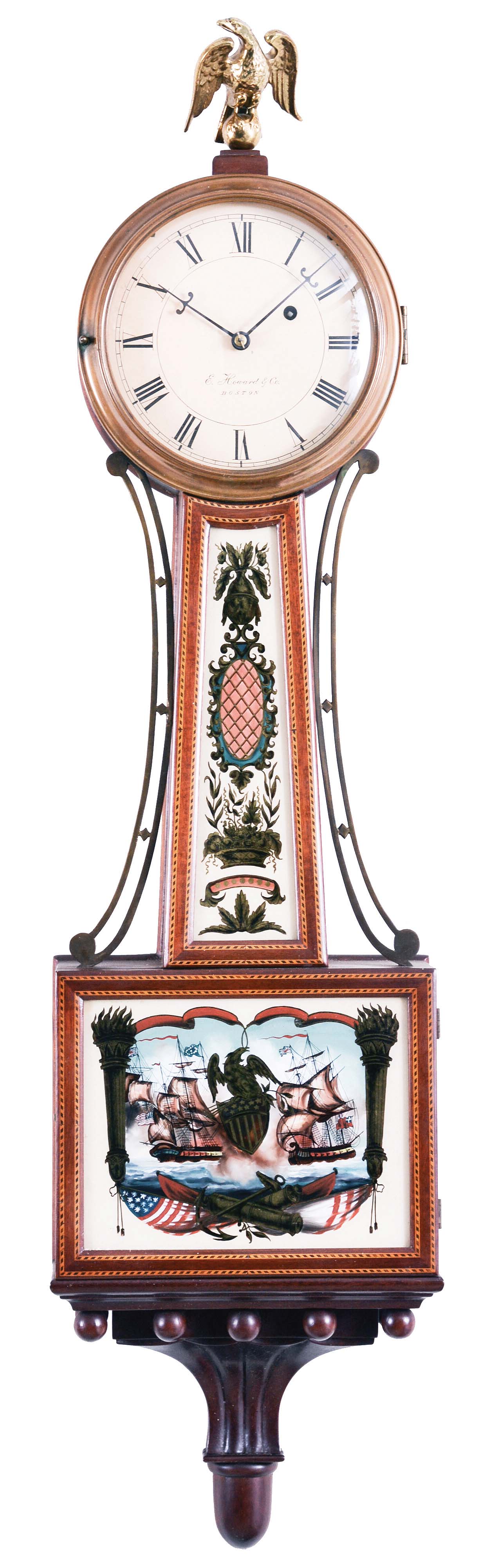 E. Howard &amp; Co. Boston, Mass., "No. 95 Banjo Clock", the special order mahogany case surmounted by a cast brass eagle finial, roman numeral dial signed "E. Howard &amp; Co./ Boston", slightly convex frames with two lines of segmented dark and light inlays frame the superb reverse-paintings on glass, the lower depicting the patriotic scene of American and British war ships (presumably the Constitution and the Guerriere) both flying their national colors set within Patriotic iconography including a draped American flag, canons, an anchor and a central eagle perched on a Federal shield for pendulum viewing all framed by gilt flaming columns, the waist glass flanked by brass side ornaments depicts a floral basket, cross-hatched cartouche and finial with draperies and floral spray, below a carved pedestal with balls and acorn drop, eight day brass weight powered movement stamped "E. Howard &amp; Co./Boston" with maintaining power, Geneva stop and recoil escapement with front plate viewing ports, all powered by a lead weight and regulated by a brass faced pendulum bob and flat wooden rod. — Antique Clocks Price Guide