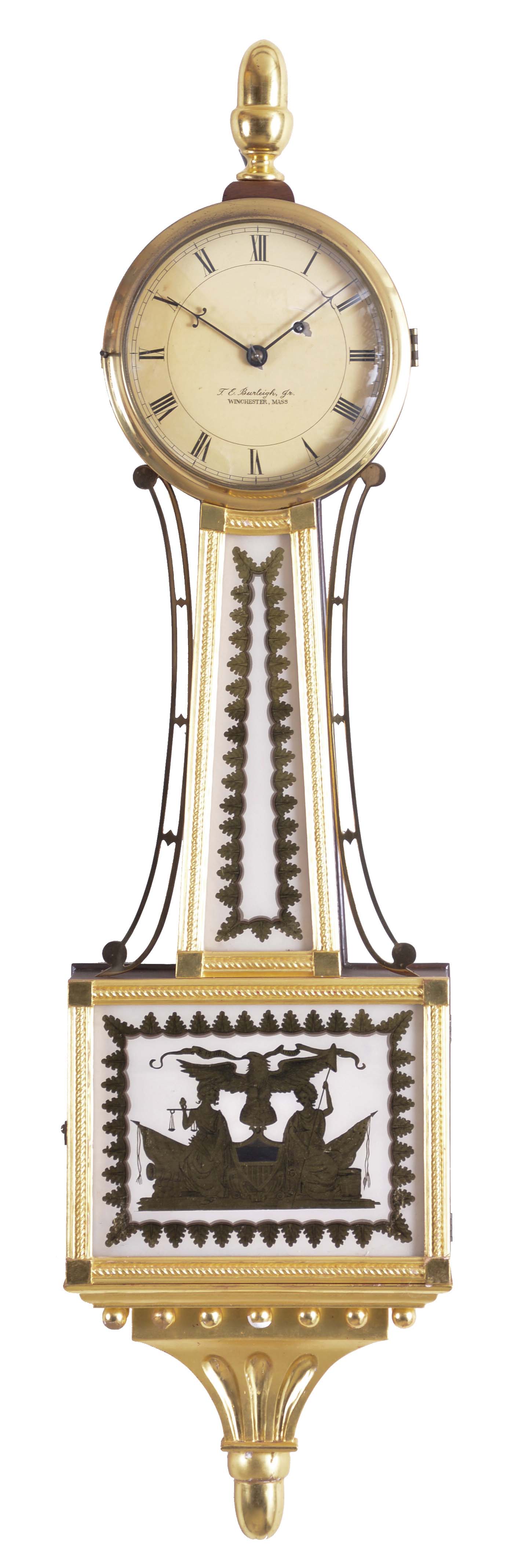 Theodore E. Burleigh, Winchester, Mass. gilt front presentation "Truth and Justice" banjo clock, with mahogany case surmounted by an acorn finial, brass bezel over the roman numeral dial signed "T. E. Burleigh, Jr./Winchester, Mass", gilded rope molded frames support reverse-painted tablets in gold and white, the lower box glass depicts Truth and Justice as mythical women holding the liberty cap and pole, and the balance scale as Justice and Equality, flanking the Federal eagle perched atop of the world globe and clutching the banner with the United States motto, "E. Pluribus Unum" (out of many, one), all set against a stage of canon balls, flags, a drum and a Federal shield as a pendulum aperture, the whole resting on a carved and gilded pediment with balls and acorn drop, eight day brass time only movement stamped "Kilbourn &amp; Proctor Inc.", with recoil escapement, all powered by a lead weight and regulated by a brass faced pendulum bob and steel rod. — Antique Clocks Price Guide