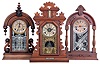 Clocks- 3 (Three): (1) Ansonia Clock Co., New York, "Parisian" shelf clock with a spring driven, 8 day, time and strike movement in a walnut case, c1880; (2) William L. Gilbert Clock Co., Winsted, Conn., "Texas" shelf clock with a spring driven, 8 day, time and strike movement in a walnut case, c1881. (3) E. Ingraham & Co., Bristol, Conn., premium model shelf clock with a spring driven, 8 day time, strike & alarm movement in a walnut case with a thermometer & level, c1880.