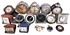 Clocks- 16 (Sixteen) Alarm, Travel, and Car: small clocks including and 8 day Waltham with black dial for the U.S. Navy, a Pierce-Arrow car clock, a Taunus 8 day car clock in brass and glass dash mount, as well as several alarm clocks and travel clocks.