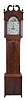 Unsigned, New Jersey tall clock, 8 day, time and bell strike, weight driven movement in a mahogany and mahogany veneer broken arch case with bracket feet, inlaid around circular crotch mahogany panel on plinth, boxwood border framing trunk door and corner columns with crotch mahogany panel, the hood door is flanked by two full columns that are inlaid with boxwood and ebony, three brass finials, brass rosettes on broken arch. The painted metal dial has female selling flowers in arch and painted fruit and bird gold spandrels and calendar disc under center arbor.