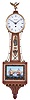 Elmer O. Stennes, Weymouth, Mass., Miniature Banjo Clock, roman numeral dial signed by maker, brass side ornaments flanking the waist glass with American shield, lower glass with British and American war ships in battle during the War of 1812 with a geometric border in red, blue and gold, both glasses held by rope molded mahogany frames, all resting on a carved mahogany pedestal eight day spring powered lever escapement movement and winding key.