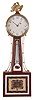 Attributed to Aaron Willard, Jr., Roxbury, Massachusetts, patent timepiece or "banjo" clock with hermometer, the mahogany case with brass eagle finial over the unmarked, painted iron roman numeral dial, held in place by three "L" shaped screws, superb original steel barbed hands, the cross-banded throat section with reverse-painted glass signed "Willard's Patent" in the lower cartouche, red and green decoration frames the thermometer with graduations from minus 40 to 260 degrees Fahrenheit and notations from "Extreme Cold" to "Water Boils", the lower glass framed with cross-banding also marked "Willard's Patent" in a banner above the pendulum aperture, red, green, gold and mustard decoration complete a geometric design bordered in white, eight day timepiece with t bridge suspension, recoil escapement, alternate train layout, holes remaining for through bolts for movement attachment to the case, all powered by a lead weight and regulated by a pendulum.
