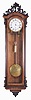 Rappel K, Budapest, large hanging Vienna regulator, 30 day, time only, brass, weight driven movement, rosewood veneer case with ebonized ripple molding and carved crest, door corners also with carved ornament, signed, Roman numeral white enamel dial with well made blued steel hands