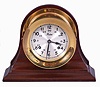 Boston by Chelsea Clock Co., Boston, Mass., marine clock, 8 day, time and strike, spring driven balance wheel movement in a polished brass case resting on the original mahogany cradle.