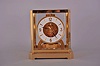 Jaeger- LeCoultre, Switzerland, "Atmos" clock, 15 jewel, caliber 528-8 movement, gilt torsion pendulum, round white painted dial with applied gilt Arabic numerals and arrow markers, gilt hands with blackened tips, all contained in a glazed rectangular case, movement serial #563139, c1983.