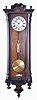 Clocks- 2 (Two) Gustav Becker Vienna Regulators: (1) Gustav Becker, Freiburg, Germany, one weight, 8 day Vienna regulator in a walnut veneer case with ebonized accents, white enamel dial with Roman numerals; (2) Gustav Becker, Freiburg, Germany, 3 weight quarter-striking, 8 day Vienna regulator in a walnut case with cast gilt metal ornaments, polychrome porcelain dial with embossed center, matching embossed brass weights and brass pendulum.