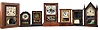Clocks- 7 (Seven): (1) Elisha Manross, Bristol, shelf clock with a spring driven 30 hour time and strike movement in a rosewood veneered case with inlay, c1850; (2) Seth Thomas, Plymouth Hollow, Conn., cottage shelf clock with a spring driven 30 hour time and alarm movement in a rosewood veneered case, c1850. (3): Brewster & Co., Bristol, Conn., cottage shelf clock with a spring driven 30 hour time and alarm movement in a rosewood veneered case, c1850. (4) Seth Thomas, Plymouth Hollow, Conn., cottage shelf clock with a spring driven 30 hour time and strike movement in a rosewood veneered case, c1850. (5) Daniel Pratt, Reading, Mass., cottage clock with a spring driven 30 hour timepiece movement in a rosewood veneered case, c1855. (6) S. B. Terry, Terryville, Conn., shelf clock with a 30 hour timepiece movement (incomplete) in a paper finished case, c1850. (7) Waterbury Clock Co., Waterbury, Conn. steeple shelf clock with a spring driven 30 hour time and strike case in a mahogany veneered case, c 1855.