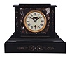 Boston Clock Co., Boston, Mass., mantel clock, 8 day, time and strike, tandem-wind movement in a black slate case with multicolor marble inserts, porcelain dial with aperture to view balance wheel escapement.
