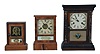 Clocks- 6 (Six): (1) Seth Thomas Clock Co., Thomaston, Conn., "Cottage Extra" shelf clock with a spring driven, 8 day, time and strike movement in a rosewood veneered case; (2) E. N. Welch, Forestville, Conn., cottage shelf clock with a 30 hour timepiece movement in a rosewood veneered case. (3) Waterbury Clock Co., Waterbury, Conn., cottage shelf clock with a spring driven 30 hour time and strike movement in a rosewood veneered case. (4) Seth Thomas Clock Co., Thomaston, Conn., cottage shelf clock with a spring driven 30 hour time and alarm movement in a rosewood veneered case. (5) Jerome & Co., New Haven, Conn., "Cottage No. 2" shelf clock with a spring driven 30 hour time, strike and alarm movement in a veneered case. (6): Gilbert Clock Co., Winsted, Conn., cottage shelf clock with a spring driven 30 hour time and strike movement in a rosewood veneered case.
