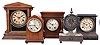 Clocks- 5 (Five) Mantel: small time and strike gothic in a mahogany case, a Sessions time and strike in an oak case, a Waterbury time and strike in a black enameled iron case, a Seth Thomas time and strike in a mahogany case sold by Henry Birks & Sons, and a time only "Tucker Bronze" in a cast iron case.