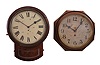 Clocks- 2 (Two) Hanging: (1) England, postal wall timepiece, 8 day, spring driven fusee movement in a walnut veneer case with painted metal dial; (2) Waterbury Clock Co., Waterbury, Conn., "Oak Lever" wall timepiece, 8 day, spring driven, balance wheel movement in an oak case with 12 inch dial.