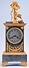 France, an attractive architectural mantel clock with animated figure, gilt and silvered bronze case, the rectangular base on gilt, scroll feet with Grecian ornament, the mid section also with cast ornament surrounding the Roman numeral silvered dial, and top with deeply molded, ornamental cornice, surmounted by a figure of Cupid with his bow and quiver, now with a smaller cupid at his feet, above a cluster of flowers, and attached to a wire linked to the pallet arbor, rocking to and fro as the clock runs, 8 day, time and strike pendule de Paris movement signed "Rodel", with silk thread suspension
