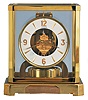 Jaeger- LeCoultre, Switzerland, "Atmos" clock, 15 jewel, caliber 528-8 movement, torsion pendulum, round white painted dial with applied gilt Arabic numerals and arrow markers, gilt hands, all contained in a glazed rectangular case with dedication plaque, serial #212045, c1966.