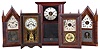 Clocks- 5 (Five): American shelf clocks: (1) Jerome's Gilbert, Grant & Co., Bristol, Conn., round side shelf clock with a weight driven 30 hour time and strike movement in a mahogany veneered case, c1839; (2) Chauncey Jerome, New Haven, Conn., steeple shelf clock with a spring driven 30 hour time and strike movement in a rosewood veneered case, c1850 (3) New Haven Clock Co., New Haven, Conn., "Gypsy Line B" shelf clock with a spring driven, 8 day, time and strike movement in an oak case, c1911. (4) Seth Thomas Clock Co., Thomaston, Conn., "Round Band" shelf clock with a spring driven 30 hour time and strike movement in a mahogany veneered case, c1870. (5) Terry & Andrews, Bristol, Conn., steeple shelf clock with a spring driven, 8 day, time and strike lyre movement in a mahogany veneered case, c1848.