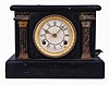 Loheide MFG. Co., St. Louis, Mo., "Automatic Sales Machine" clock and trade stimulator (often called a gambling clock). 8 day, time and token dispenser, spring driven in a black enameled wood case. The clock has a coin slot at the top. When a nickel was deposited, it triggered the strike train of the clock which drives a token dispensing system. A modified countwheel will dispense one, two, and on rare occasion, three tokens in the tray mounted to the side of the clock. Tokens were then exchanged for small items at the retail location.
