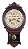 Wm. L. Gilbert Clock Co., Winsted, Conn., "Office Drop Calendar" clock, 8 day, time and strike, with Gilbert's version of the famous Maranville's calendar system, and in a walnut case with carved trim.