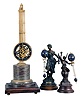 Clocks- 3 (Three) Asian Reproduction Mystery Clocks: (1) Winged male figure with bronze finish supporting swing arm with dark blue spheres, 12.5 inches; (2) Female figure with bronze and verdigris patina supporting a swinging arm with dark blue spheres, 15 inches. (3) Upside-down swinging clock on brass stand with dark red marble base on wood platform, 28 inches in height.