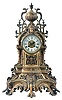 France, Mantel Clock with porcelain roman numeral dial and decorative cast center, blued-steel hands, complicated classical-styled cast brass case with urn finial at the top flanked by griffins, a female goddess of the sun life mask surmounting the dial, four fluted columns supporting the whole and a leaf and scroll base with cross hatching and four scroll-leafed feet, round brass French eight day movement with rack hour striking on a gong and pendulum.