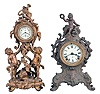 Clocks- 2 (Two): (1) Waterbury Clock Co., Waterbury, Conn., 30 hour, spring brass lever movement figural timepiece with brilliant surround dial, c1900; (2) Ansonia Clock Co., New York, "Cygnet", 8 day, time and strike, spring brass movement cast metal case with a figure on top mantel clock, c1904.