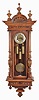 Germany / Austria, a "Vienna" regulator, grand sonnerie, 3-weight with matched pattern weights, dial and pendulum, and in a well made mixed hardwood and walnut veneer case with carved & reeded splt columns to the side of the case and with "built-in" top. The silvered brass chapter ring with Arabic numerals.