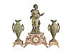 France, Variegated Pink Marble Figural Clock Garniture, the clock with off-white arabic numeral dial within a brass bezel and beveled glass set within the marble case with scroll work dial surround, on raised feet and and plinth for the statue titled "La Cigale" a sculpture first presented by Sylvain Kinsburger, the patinated figure of a young maiden no doubt playing the 'Song of the Cicada' on her lute, eight-day spring powered, round French movement with count-wheel hour and half hour strike on a bell, together with two matching and imposing ewers with floral facades and carrying handles on raised pink marble bases with gilt feet.