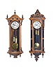 Clocks- 3 (Three) Vienna Regulator, double brass weight driven, time and strike: one in cherry with carved crest and ebony highlights, the other two in walnut