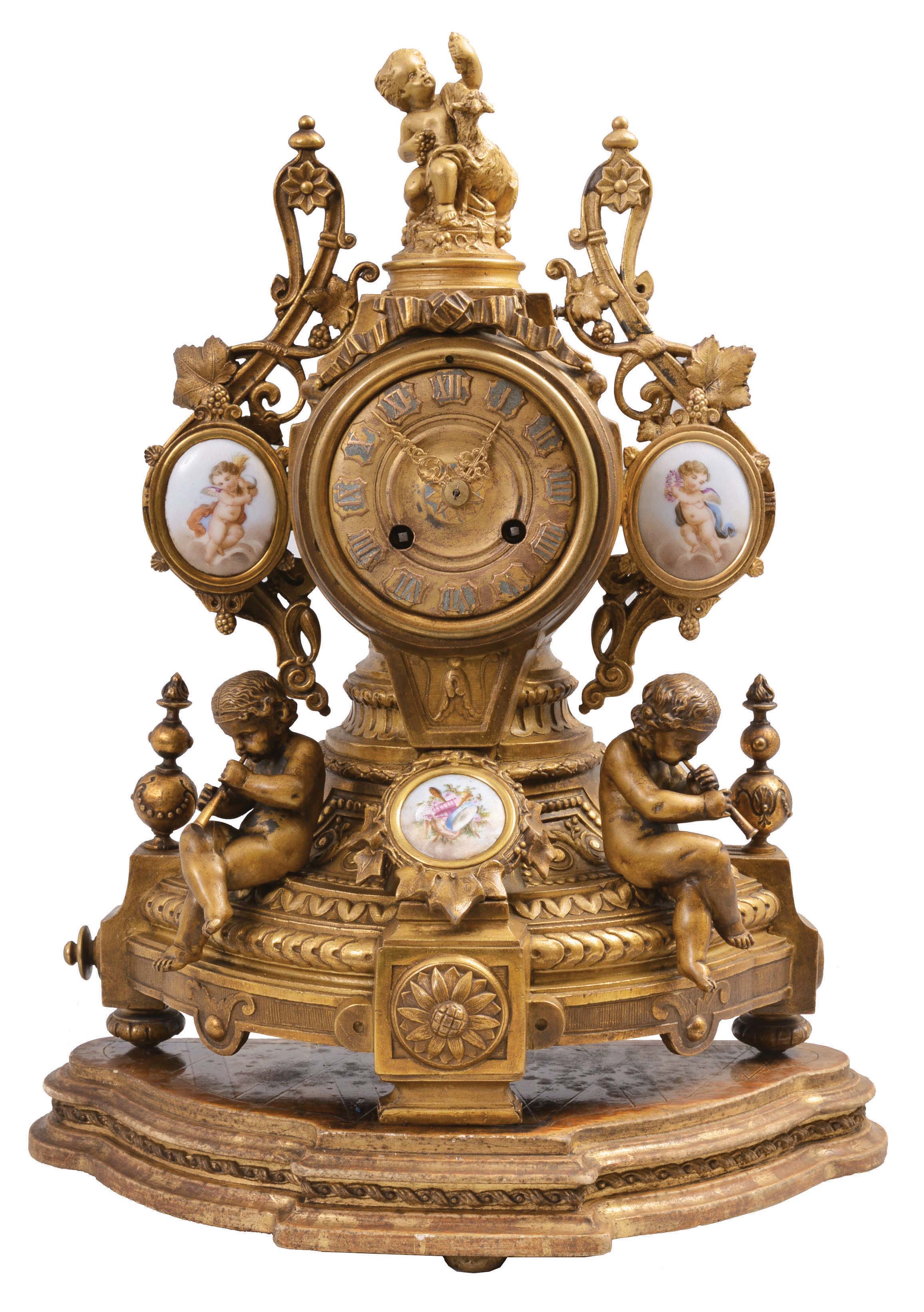 Japy Freres, Paris, figural mantel clock, 8 day, time and strike, spring-driven, pendule de Paris movement in a cast spelter case signed "Ph. Mourey" having a Rococo base with two child figures blowing horns, three polychrome painted porcelain panels with putti figures, and topped by the figure of a child feeding grapes to a goat. Comes with associated wood base. — Antique Clocks Price Guide