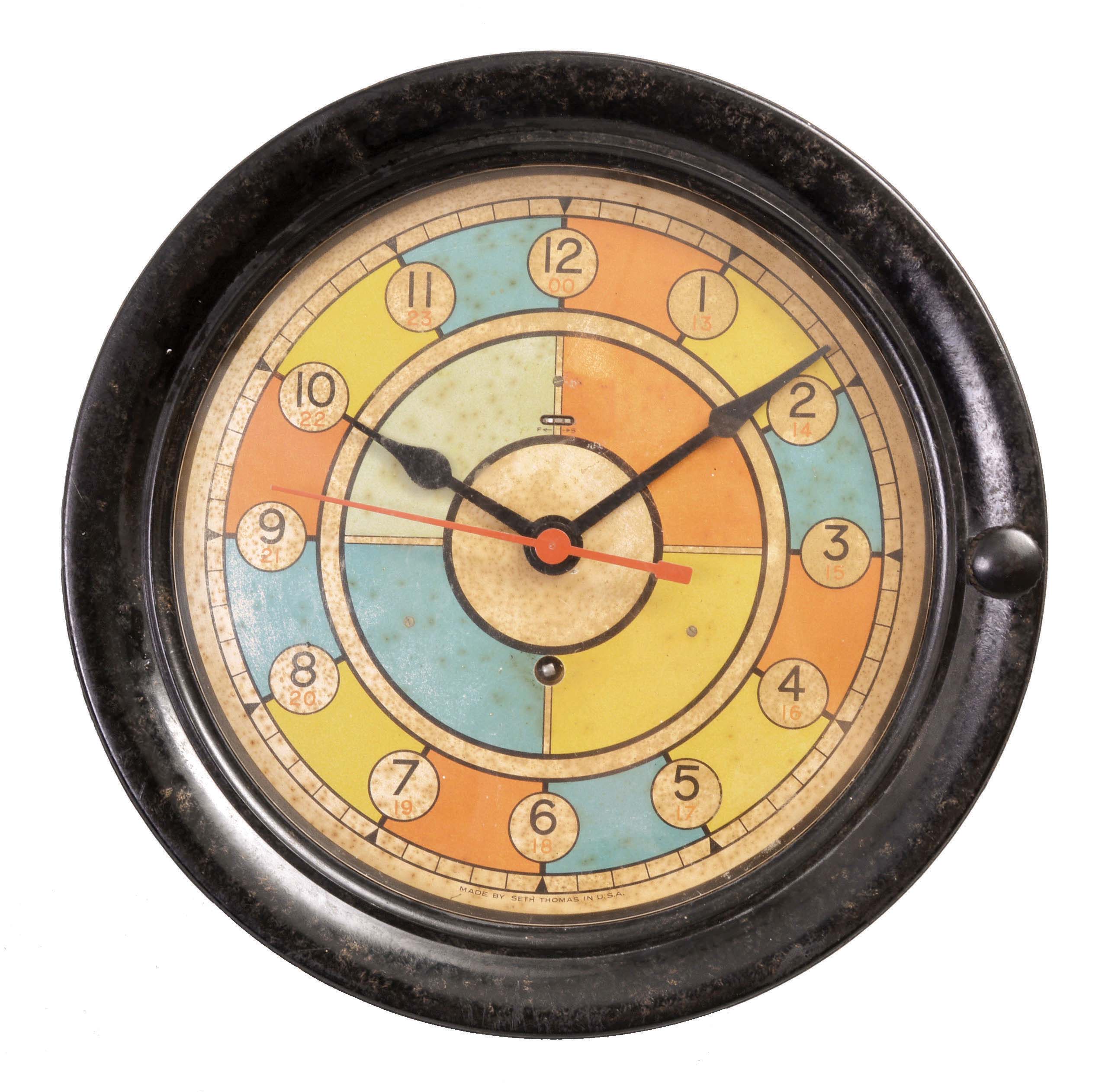 Seth Thomas Clock Co., Thomaston, Conn., "Operations Room Plotting Clock" or sector/radio room clock, 8 day, time only, spring-driven, balance wheel movement with center seconds in a black phenolic case with 8 inch polychrome dial that was used by the military, in conjunction with radar and observers, to track the movements of enemy aircraft. — Antique Clocks Price Guide