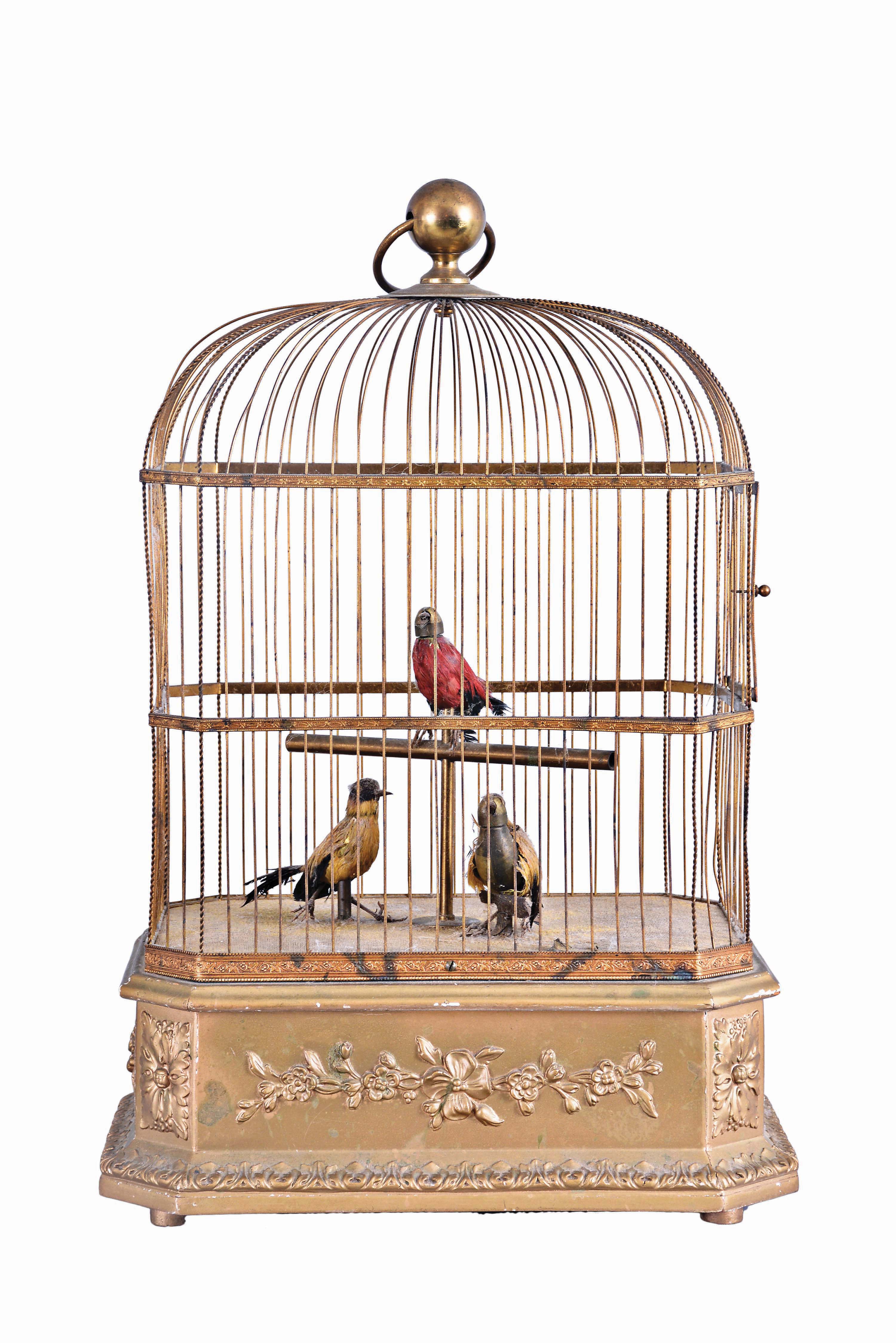 France, attributed to Bontems, automata with three caged, singing birds, the gilt cage having a rectangular wooden base with canted corners, decorated with foliate ornament, and containing the keywound mechanism, the cage containing brightly colored, life size songbirds who vocalize, turn their heads and flick their tails in turn when activated — Antique Clocks Price Guide