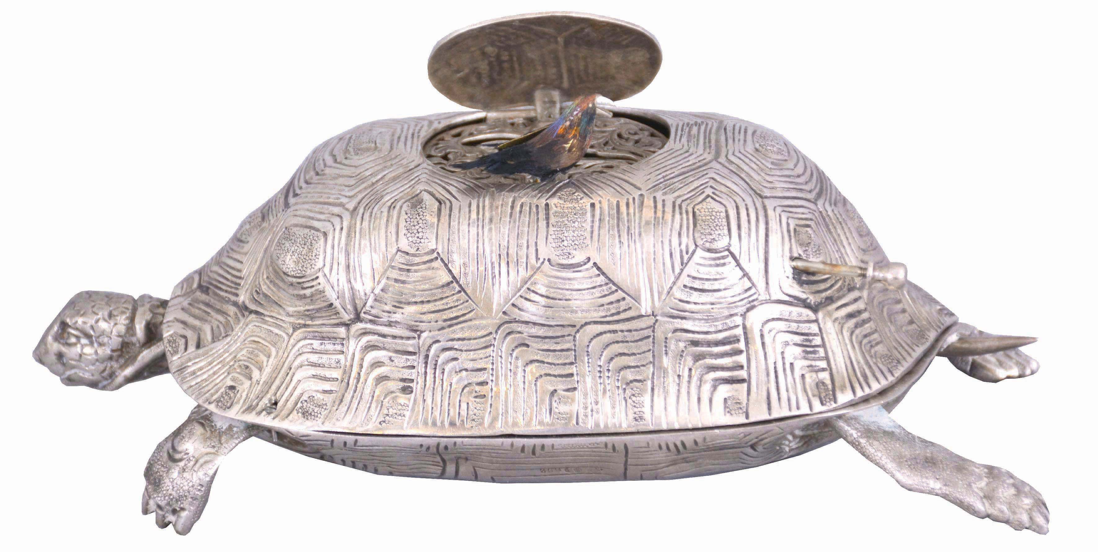 Germany, turtle form singing bird box in silver, the bird activated by a pull slide at the rear, the turtle head moving back and forth as the bird performs — Antique Clocks Price Guide