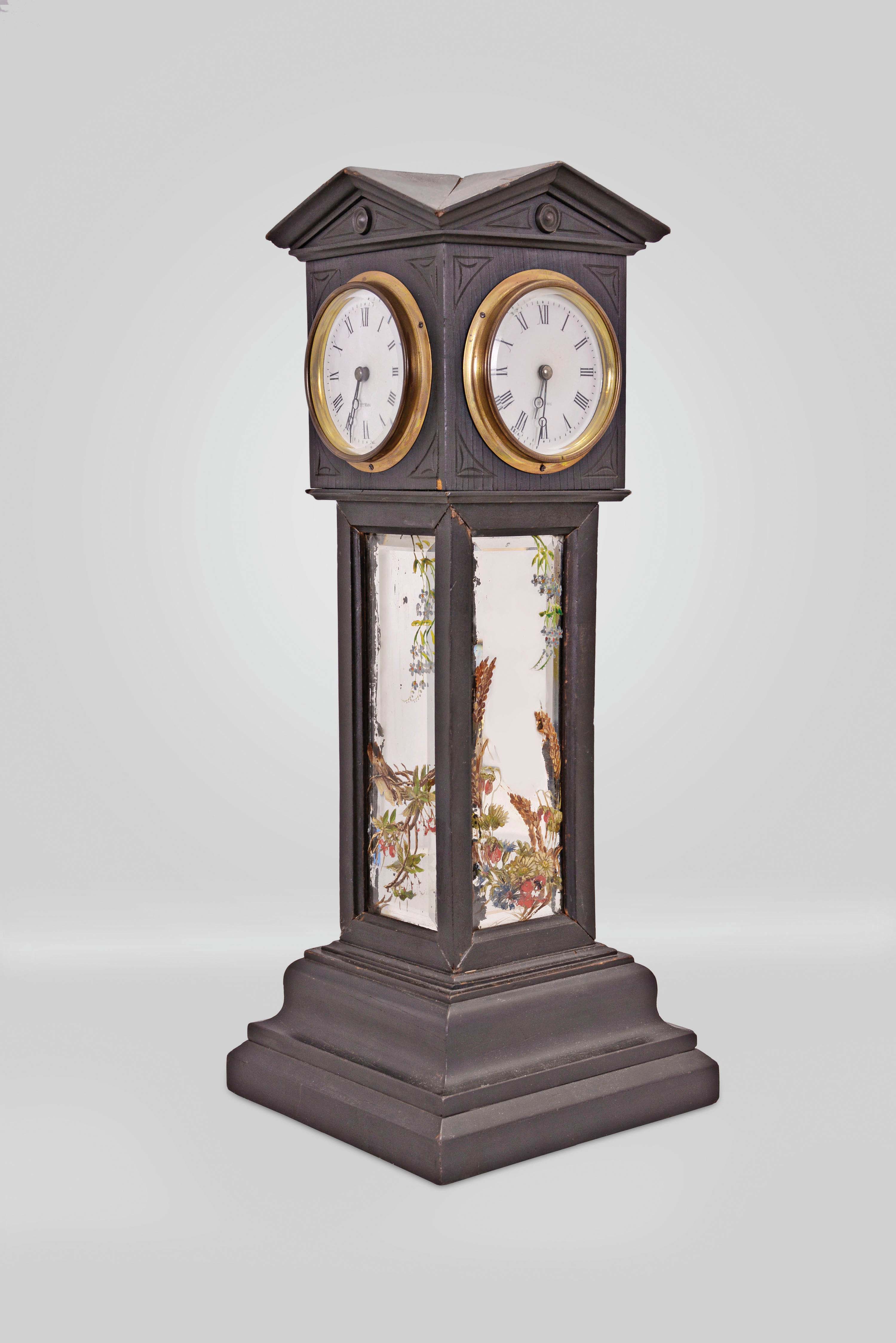 Blumberg and Co. Ltd., Paris &amp; London, a four dial, architectural, tower form clock, the ebonized case with deeply molded, stepped base, supporting cavetto molded frames containing beveled mirrors with polychrome painted floral ornament, and surmounted by a cube with pedimented top, containing the transmission gearing for four, roman numeral white enamel dials with blued steel Breguet style hands and beveled glasses in brass bezels, the dials signed "Hry. Marc", the base containing an 8 day, timepiece with oval plates and lever platform, the base also bearing an embossed, brass tag marked "Patent Brevete S.G.D.C. Blumberg &amp; Co. Ltd Paris &amp; London" — Antique Clocks Price Guide