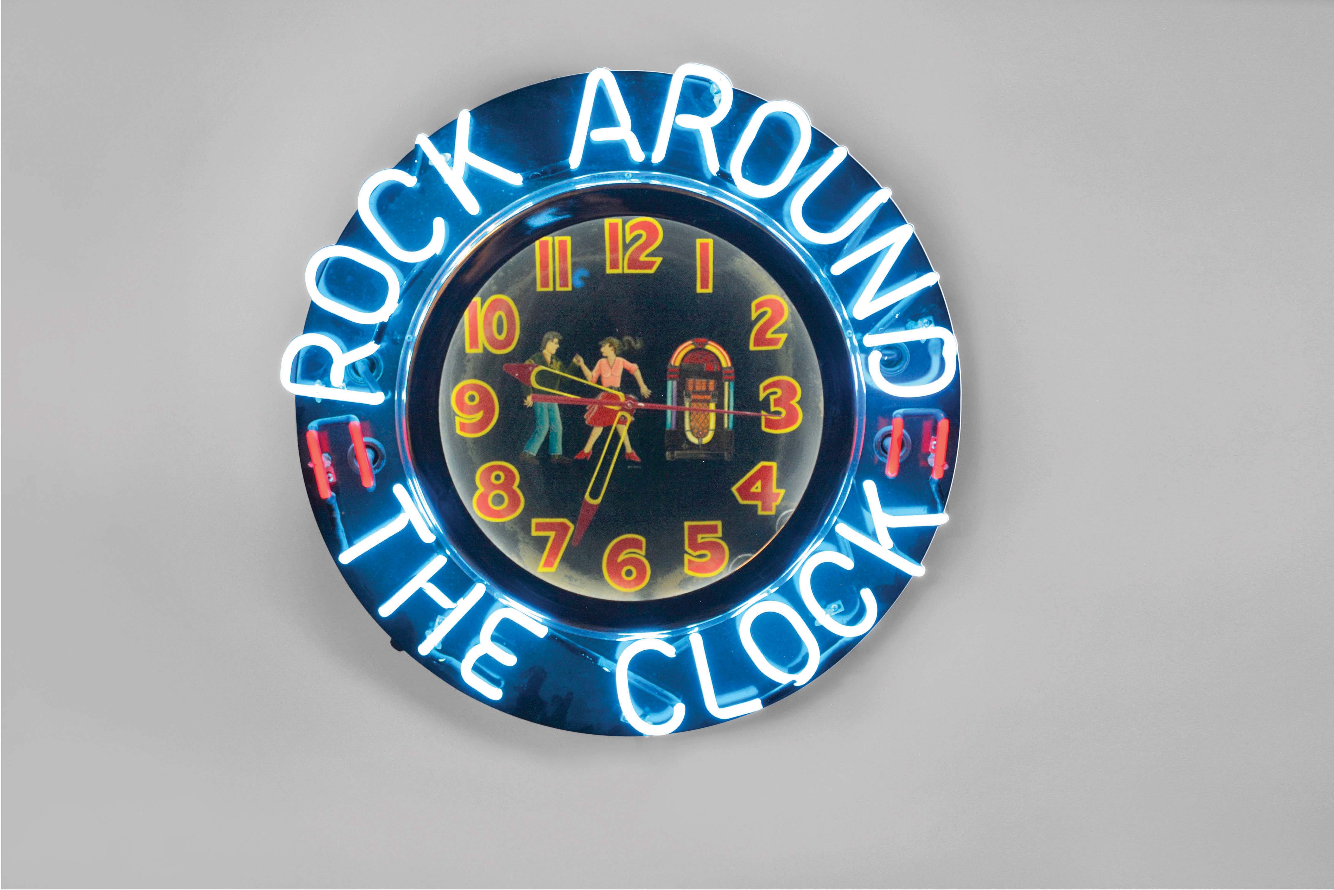 Neon gallery wall clock, "ROCK AROUND THE CLOCK", electric driven, time only movement with large 15in black dial, Arabic numerals and blue and red lighted neon perimeter displaying "ROCK AROUND THE CLOCK" — Antique Clocks Price Guide