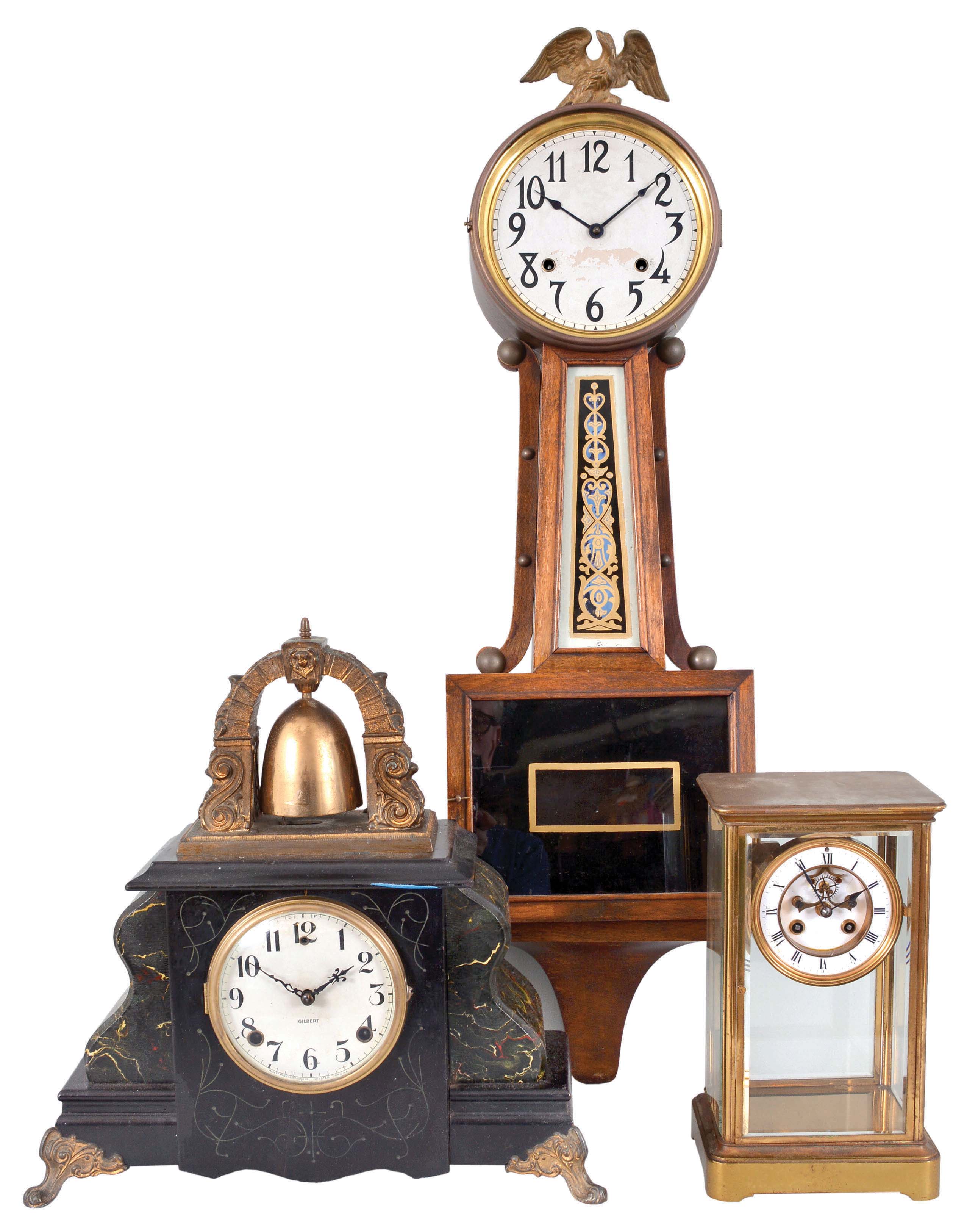 Clocks- 3 (Three) Time and Strike: (1) France, crystal regulator, 8 day, time and strike, spring-driven pendule de Paris movement with a visible Brocot escapement in a glazed brass case with white enamel dial with Roman numerals, c1910; (2) E. Ingraham, Bristol, Conn., "Nyanza" banjo clock, 8 day, time and strike, spring-driven movement in a mahogany case with white paper dial and large eagle finial, c1915; (3) Wm. L. Gilbert Clock Co., Winsted, CT "Curfew", 8 day, time and strike, spring-driven movement in a black enameled wood case with marbelized sides and prominent bell on top, c1910. — Antique Clocks Price Guide