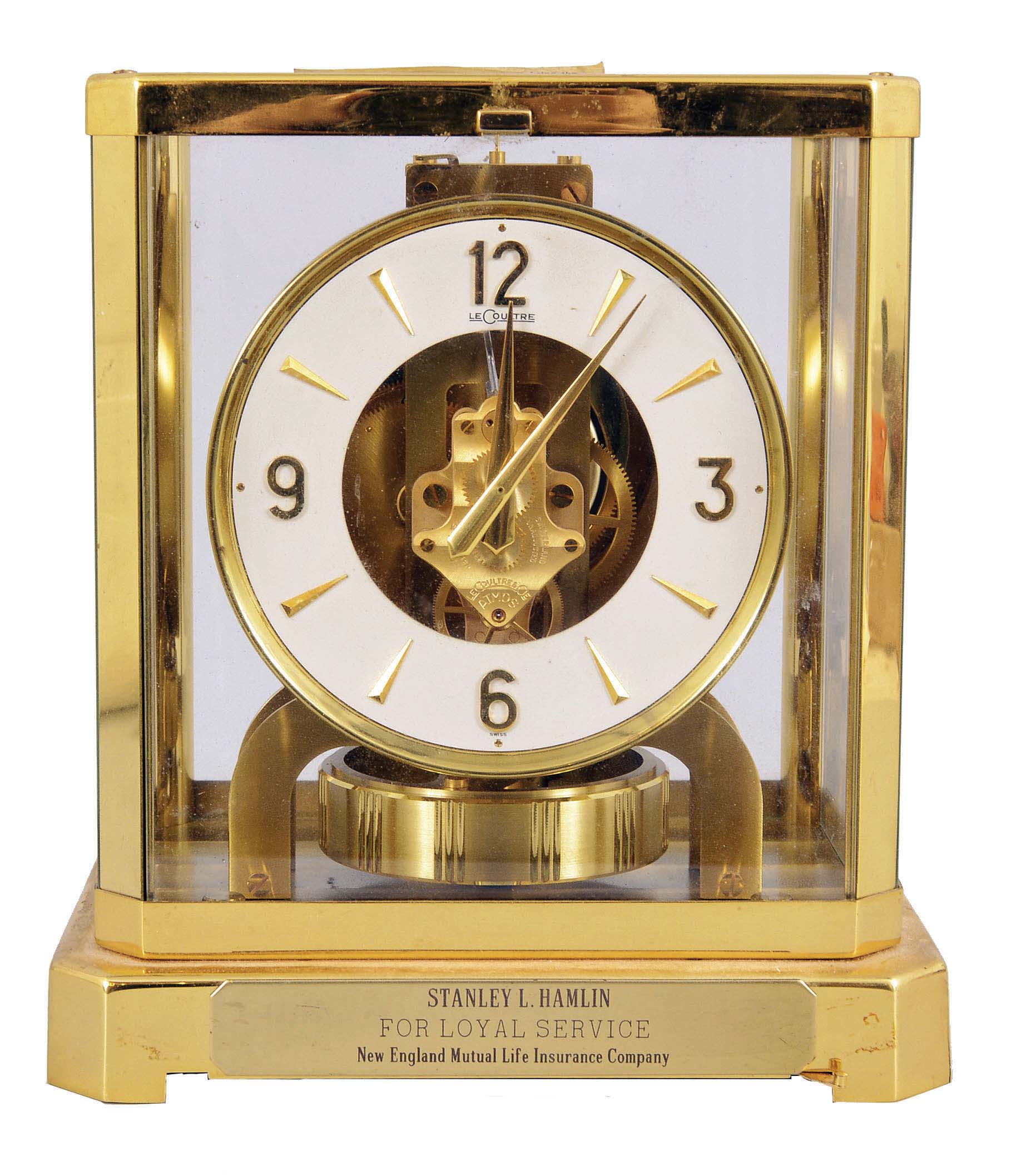 Jaeger- LeCoultre, Switzerland, "Atmos" clock, 15 jewel, caliber 528-8/6 movement, torsion pendulum, round metal dial with applied gilt arrow markers and numbers, gilt hands, all contained in a glazed rectangular case with original styrofoam packaging box, serial #220770. — Antique Clocks Price Guide