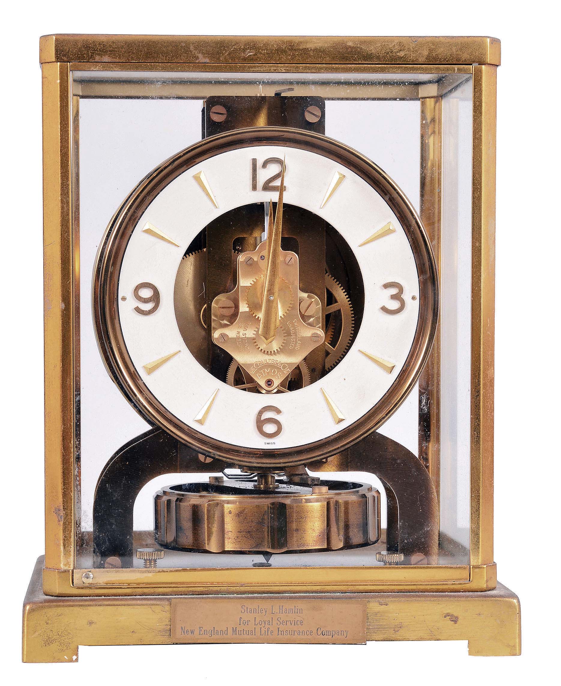 Jaeger- LeCoultre, Switzerland, "Atmos" clock, 15 jewel, caliber 526-5 movement, torsion pendulum movement with round metal dial, applied gilt arrow markers and numbers, gilt hands, in a glazed rectangular case with hinged font door, original cloth-covered box, serial #106500. — Antique Clocks Price Guide