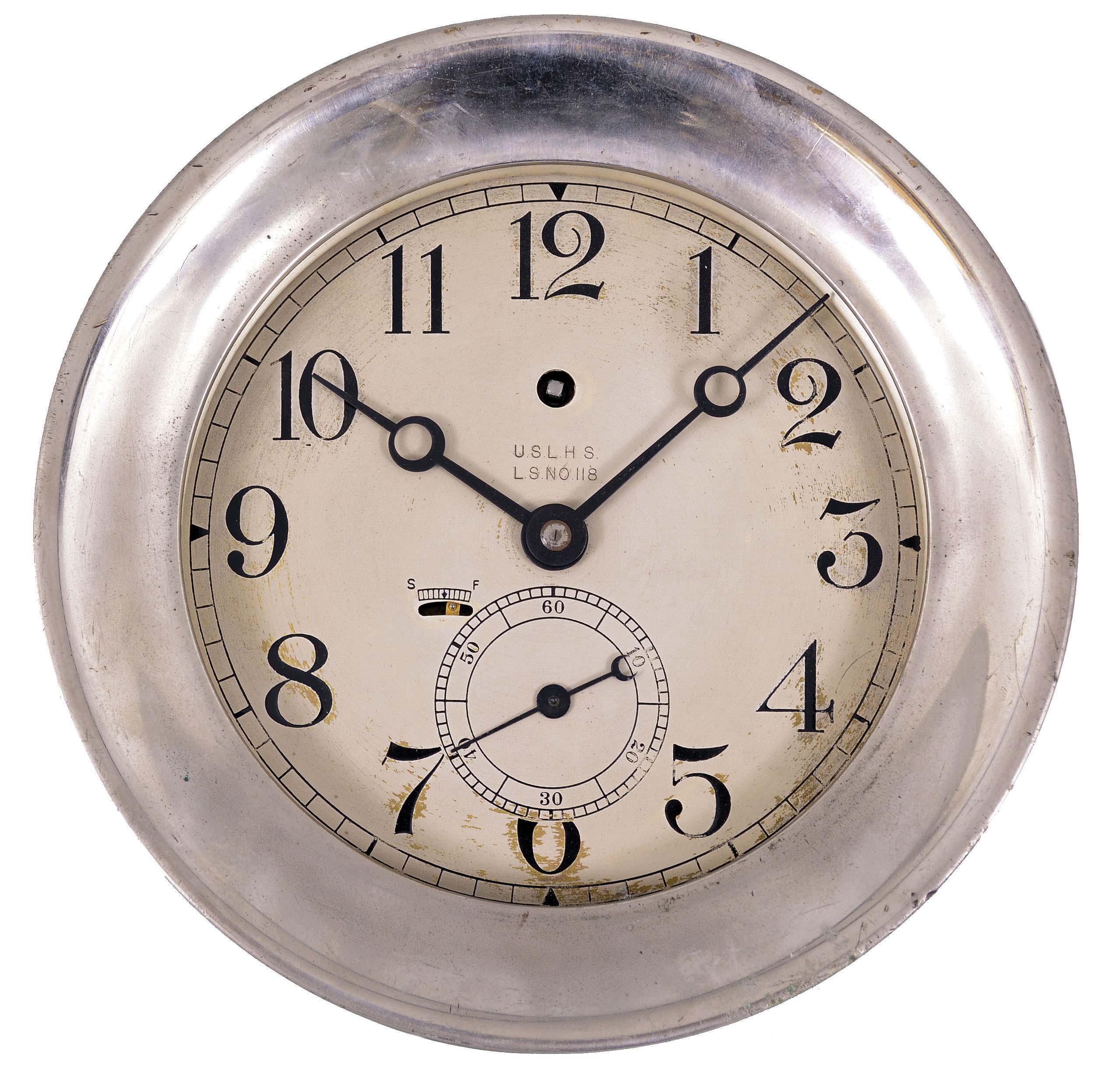 Chelsea Clock Co., Boston, Mass., for U.S. Light House Service, deck clock, 8 day, time only, spring-driven jeweled balance wheel movement in a nickel plated case with hinged bezel, 6.5 inch silvered dial and large subsidiary seconds, signed "USLHS, LS NO 118" indicating that it was on the Lightship "Overfalls" (LV-118). — Antique Clocks Price Guide