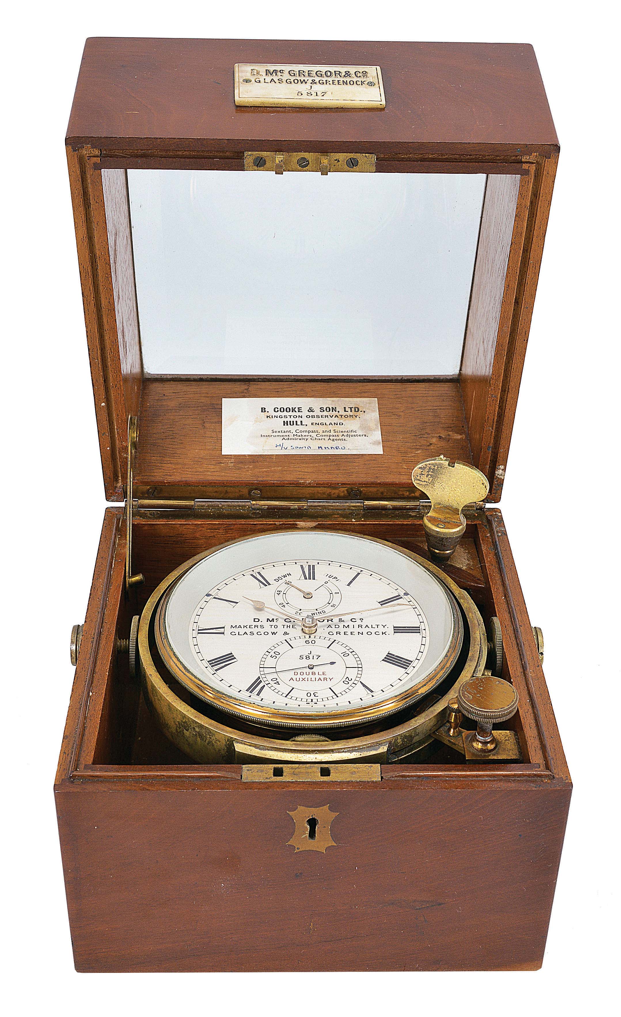 D. McGregor and Co., Glasgow &amp; Greenock, a two day marine chronometer with double auxiliary balance, 10 jewel fusee movement with Earnshaw's escapement, and freesprung, cut bimetallic balance with Poole's and Eiffe's auxiliary compensation, diamond endstone, and blued steel helical balance spring, Roman numeral silvered dial with wind indicator, gold spade and poker hands, contained in a lacquered brass bowl, and mounted in an associated two tier mahogany box with gimbals, bevelled glass top, and lacquered brass furniture, serial #J/5817 — Antique Clocks Price Guide