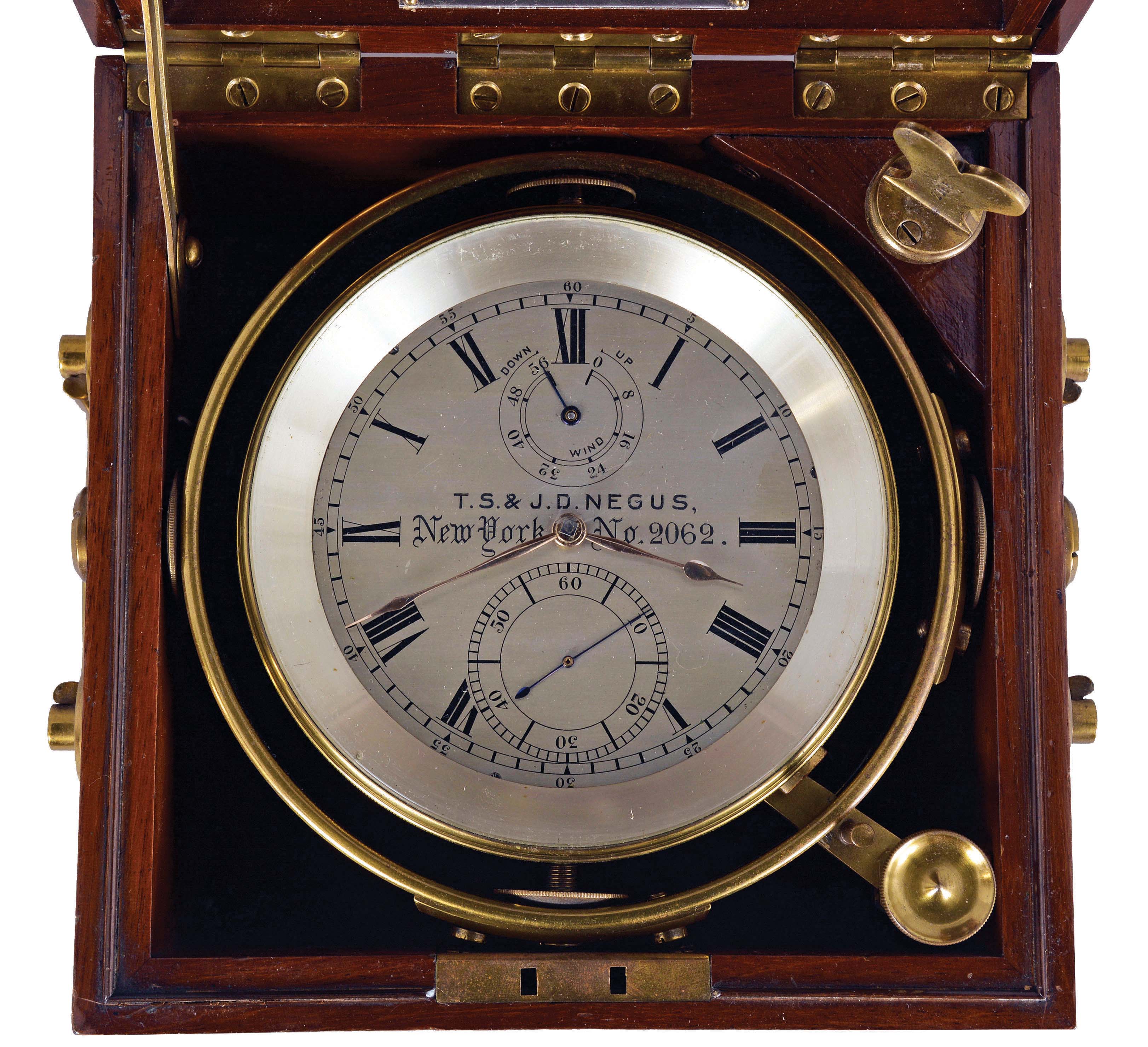 T.S. &amp; J.D. Negus, New York, two day marine chronometer, 11 jewel fusee movement with spotted plates, Earnshaw's escapement, freesprung, cut bimetallic "H" balance, diamond endstone, and blued steel helical balance spring, Roman numeral silvered dial with wind indicator and gold spade and poker hands, contained in a gimballed, lacquered brass bowl, all in a three tier mahogany box with brass furniture, serial #2062 — Antique Clocks Price Guide