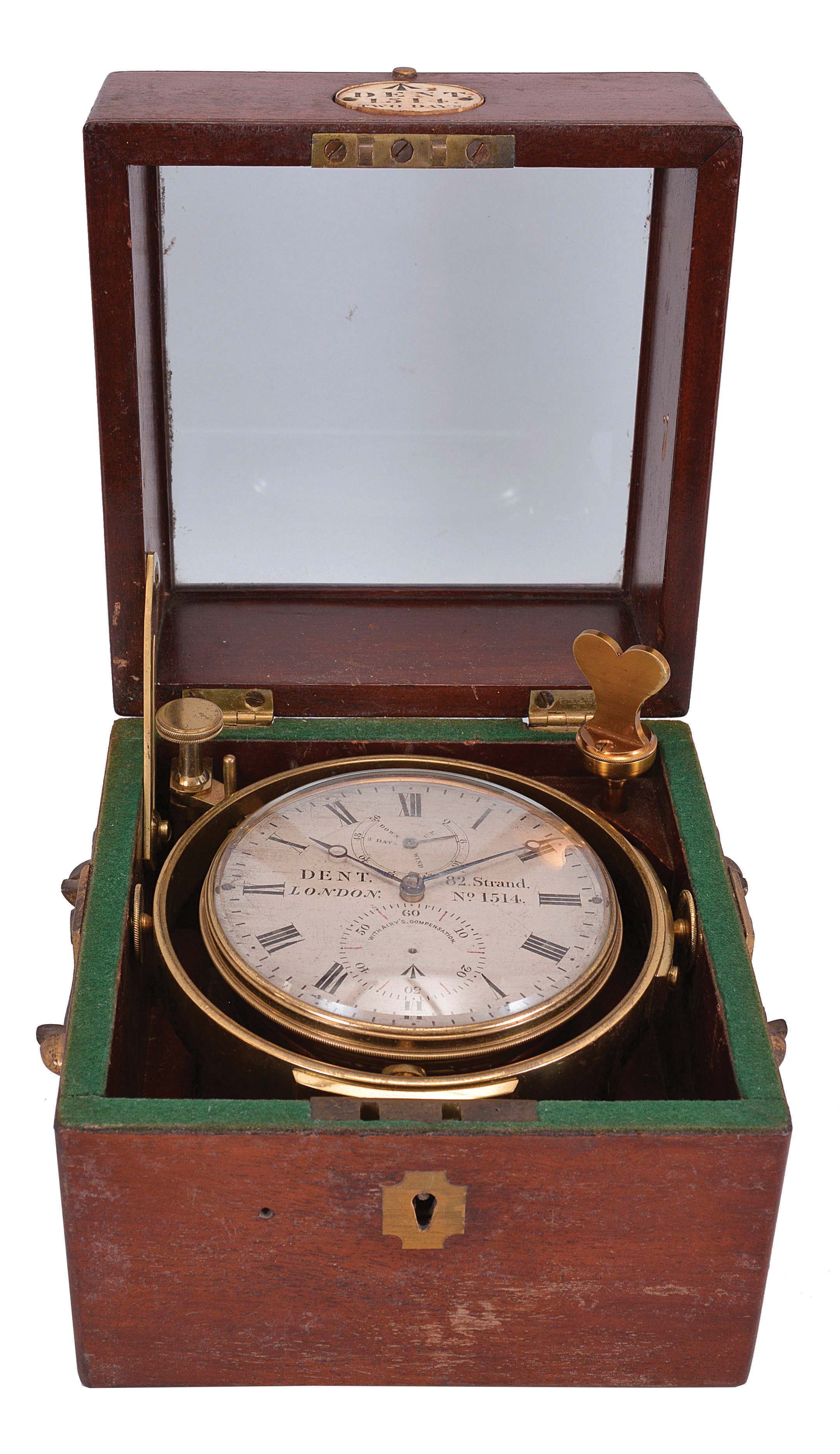 Dent, 82 Strand, London, two day marine chronometer, 11 jewel fusee movement with engraved broad arrow mark, Earnshaw's escapement, freesprung, cut bimetallic "Z" balance, diamond endstone, and helical balance spring, Roman numeral silvered dial with wind indicator, blued steel Breguet style hands, and seconds bit marked "With Airy's Compensation", housed in a gimballed, lacquered brass bowl, and contained in a two tier rosewood box with brass furniture and engraved plaque, with broad arrow mark, and "Dent, 1514, Two Days", serial #1514 — Antique Clocks Price Guide