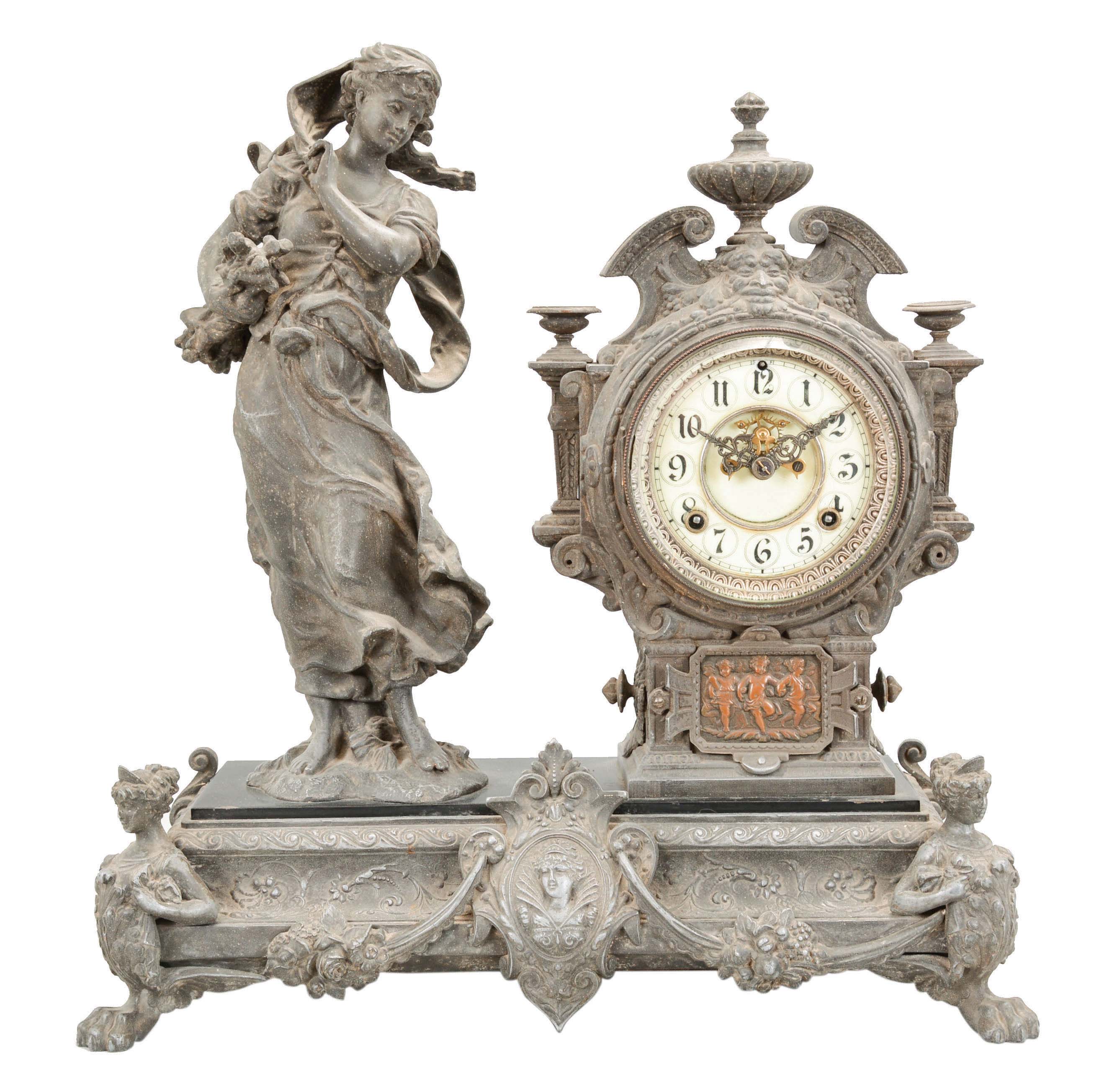 Ansonia Clock Co., New York, "Winter" statue mantel clock with an 8 day spring driven time and strike movement with visible escapement in an enameled iron base with a bronzed spelter statue. — Antique Clocks Price Guide