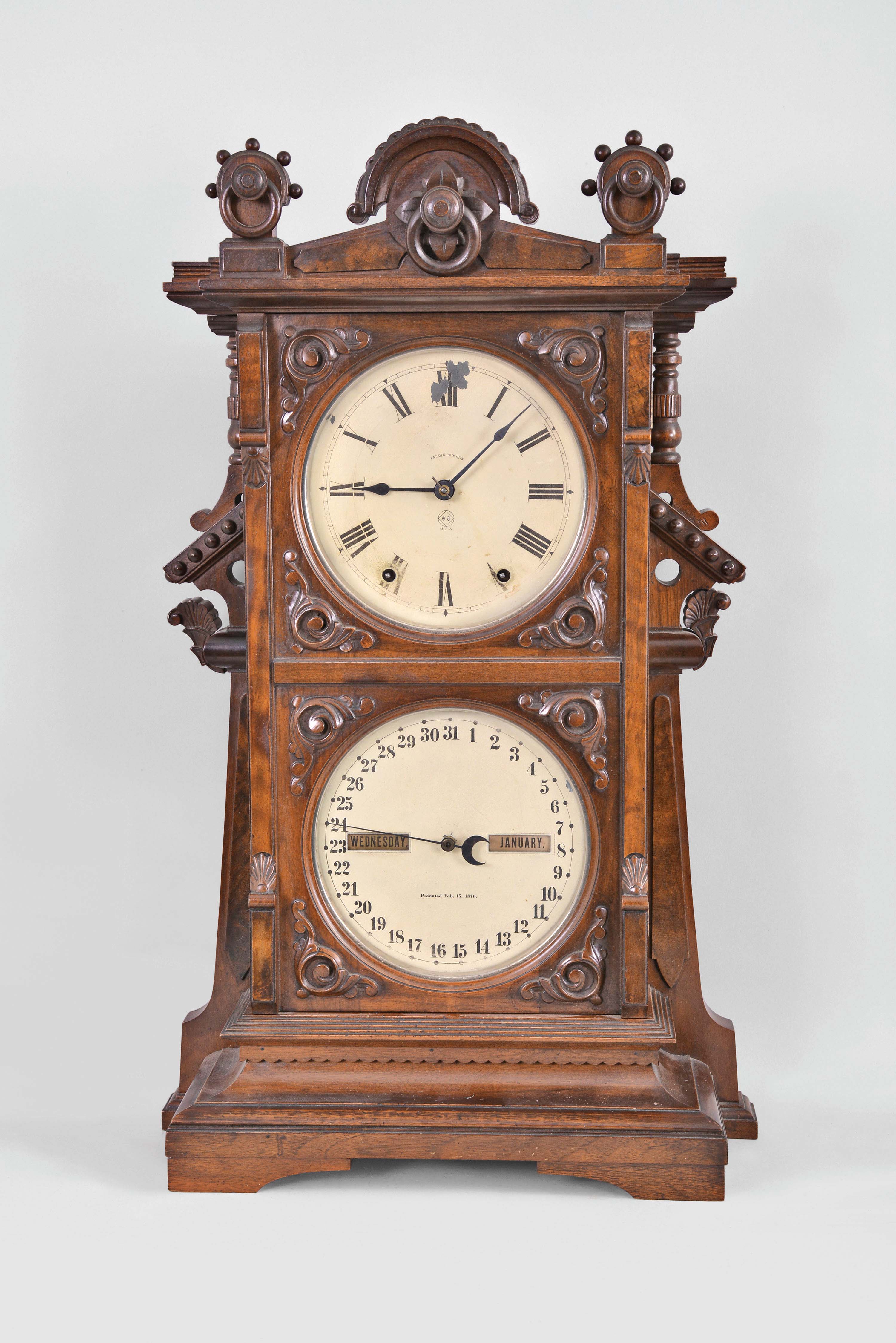 Seth Thomas Clock Co., Thomaston, Conn., "Parlor Calendar No. 9" shelf clock, 8 day, time, strike on cathedral gong and perpetual calendar, spring driven movement in a walnut case with burl and carved highlights and painted metal dials — Antique Clocks Price Guide