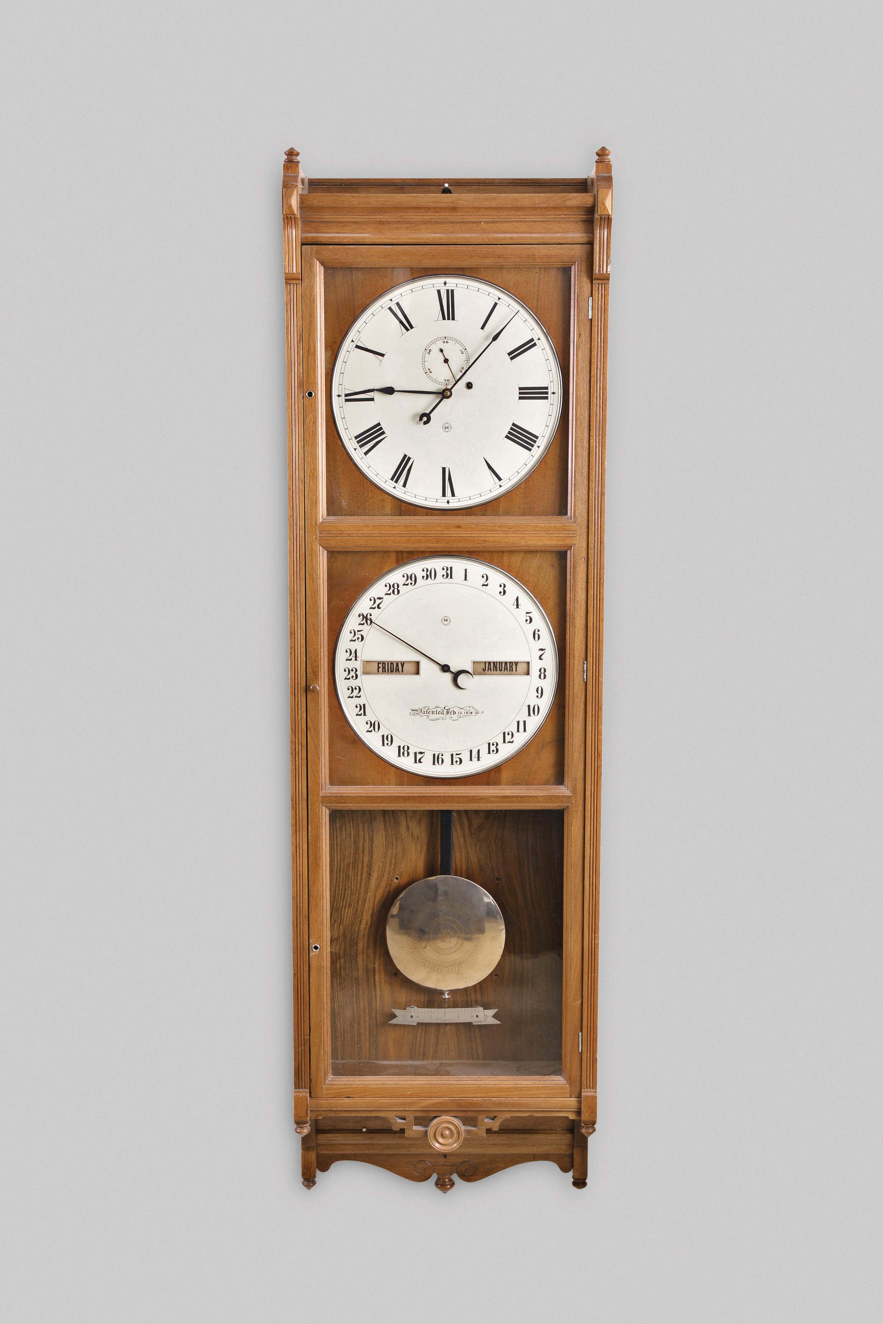 Seth Thomas Clock Co., Thomaston, Conn., "Office Calendar No. 9" hanging jeweler's regulator, 8 day, weight driven movement with perpetual calendar in a walnut case with painted metal dials, nickel damascened pendulum bob and beat scaler — Antique Clocks Price Guide