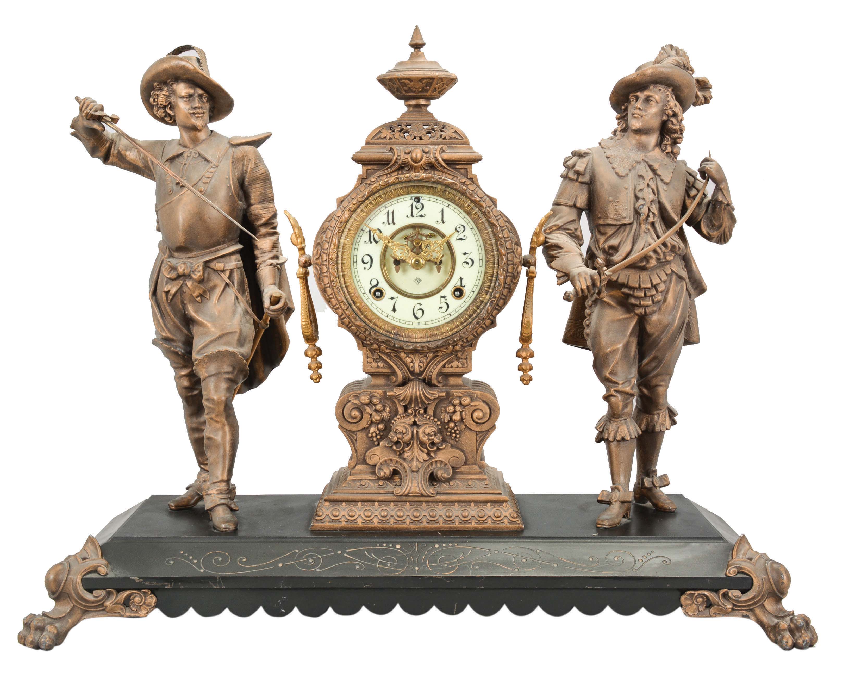 Ansonia Clock Co., New York, "Don Caesar and Don Juan" figural shelf clock with a spring driven, 8 day, time and half hour strike movement with visible escapement in an enameled iron base with two Japanese bronze spelter statues. — Antique Clocks Price Guide