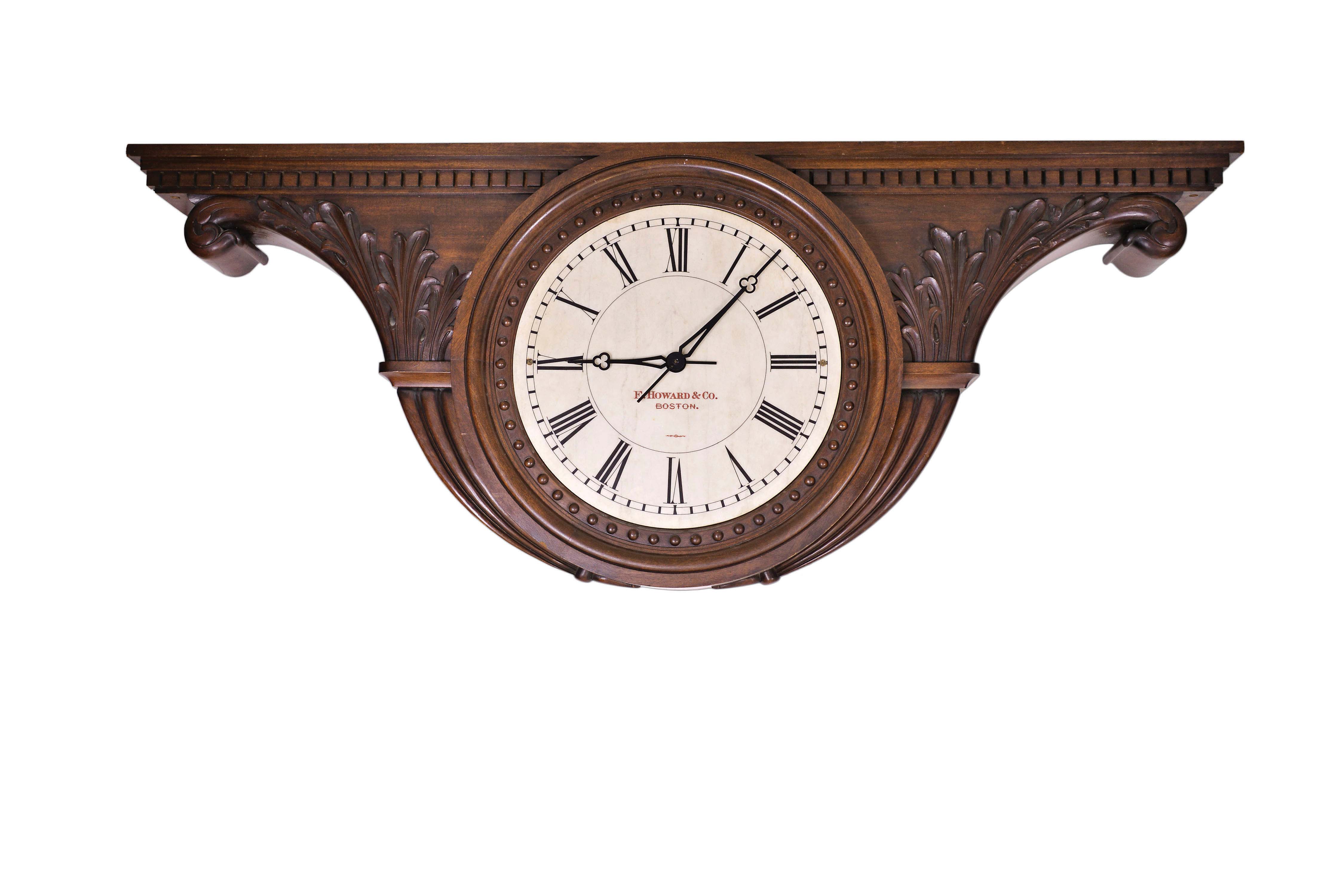 E. Howard &amp; Co., Boston, Mass., monumental double sided ceiling mounted gallery clock, 8 day, time only, weight driven movement in a elaborately carved tambour shaped mahogany case with acanthus leaves, dental molding, small hemispherical ornaments surrounding dials and tapered, fluted raised moldings on sides and bottom of case. The two marble dials are both signed "E. HOWARD &amp; CO. BOSTON". — Antique Clocks Price Guide