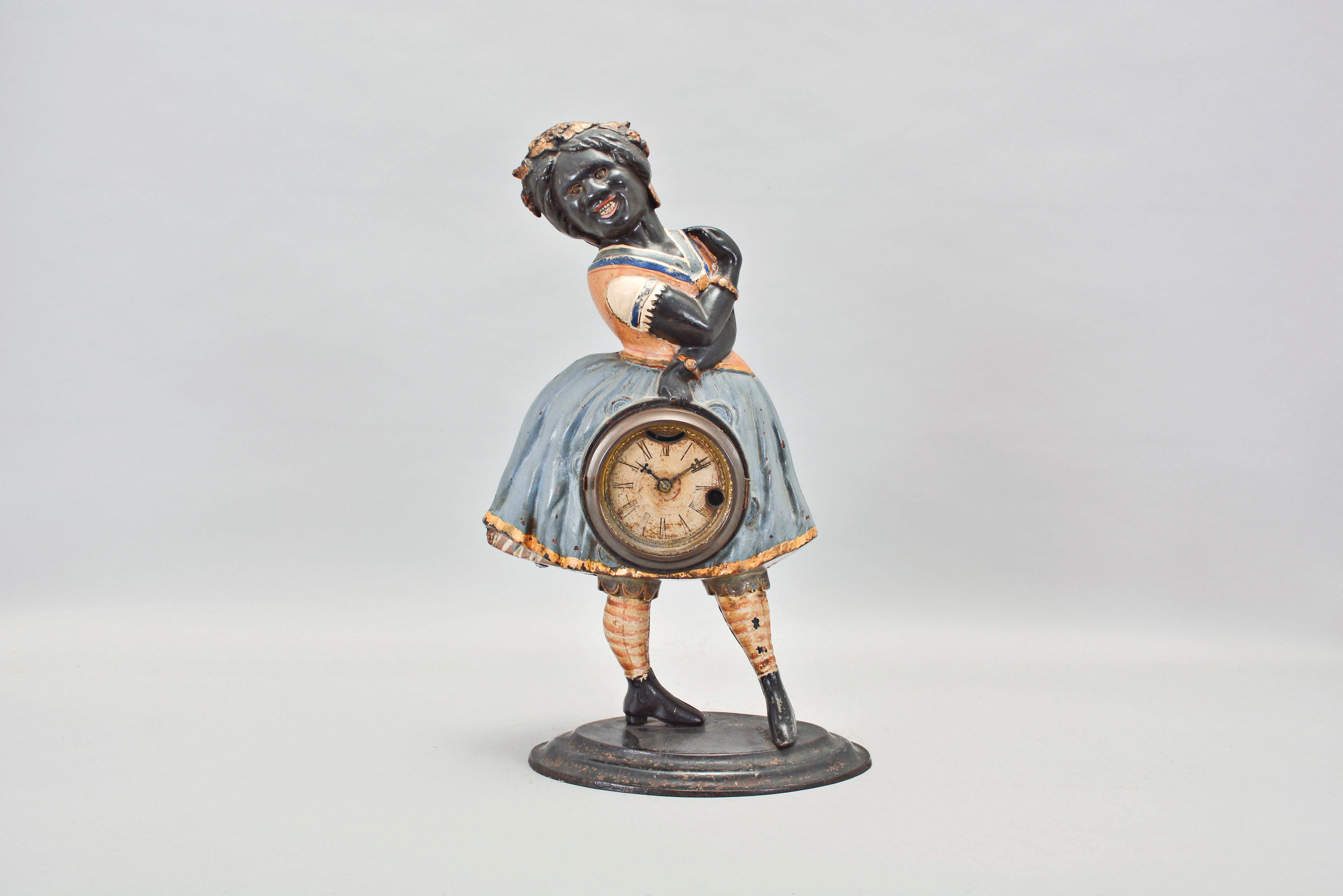 Bradley &amp; Hubbard, Meriden, Conn., "Topsey" blinking eye shelf clock with a spring driven, 30 hour, timepiece with a balance wheel escapement in a painted cast iron case. — Antique Clocks Price Guide