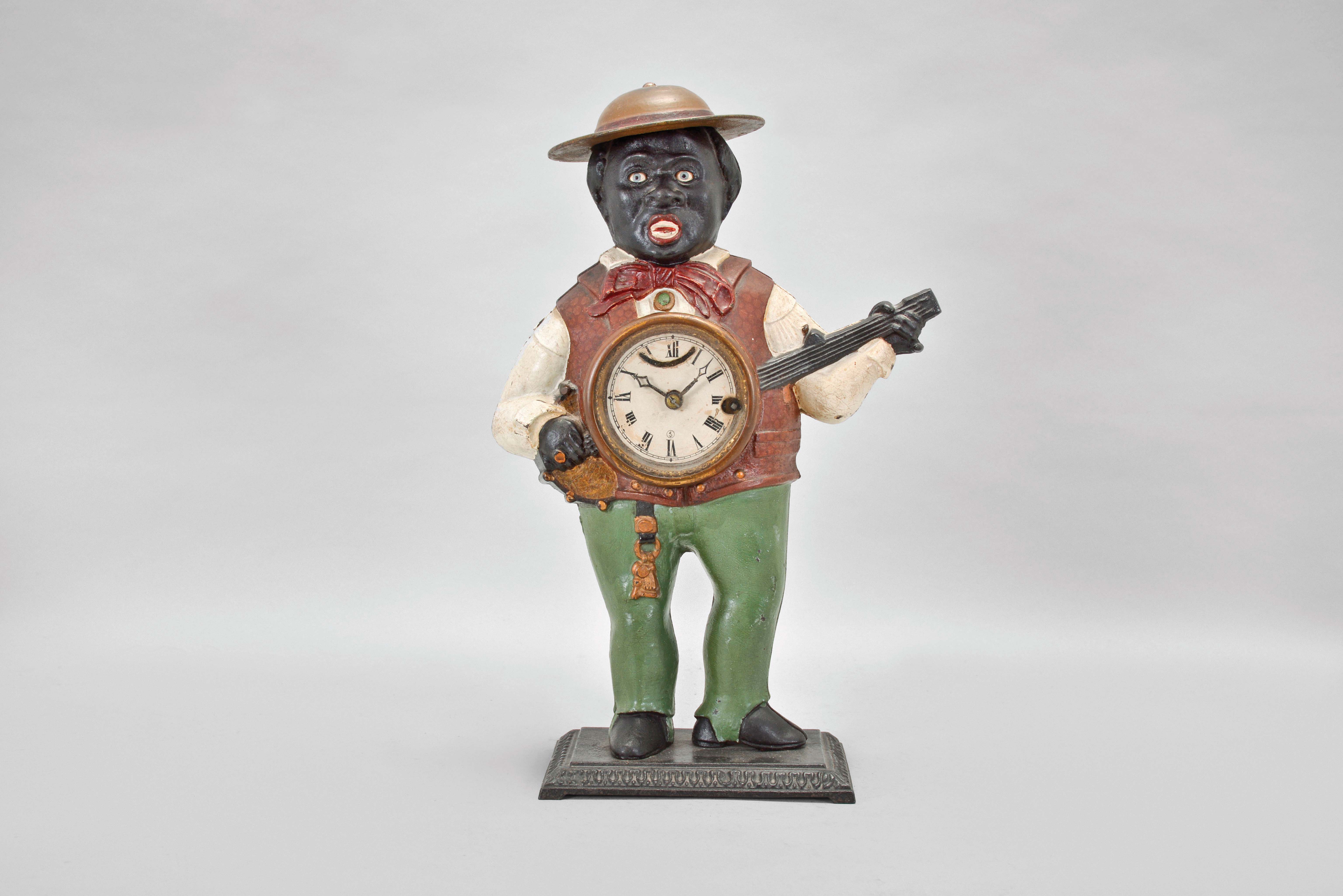 Bradley &amp; Hubbard, Meriden, Conn., "Sambo" blinking eye shelf clock with a spring driven, 30 hour, timepiece with a balance wheel escapement in a painted cast iron case. — Antique Clocks Price Guide