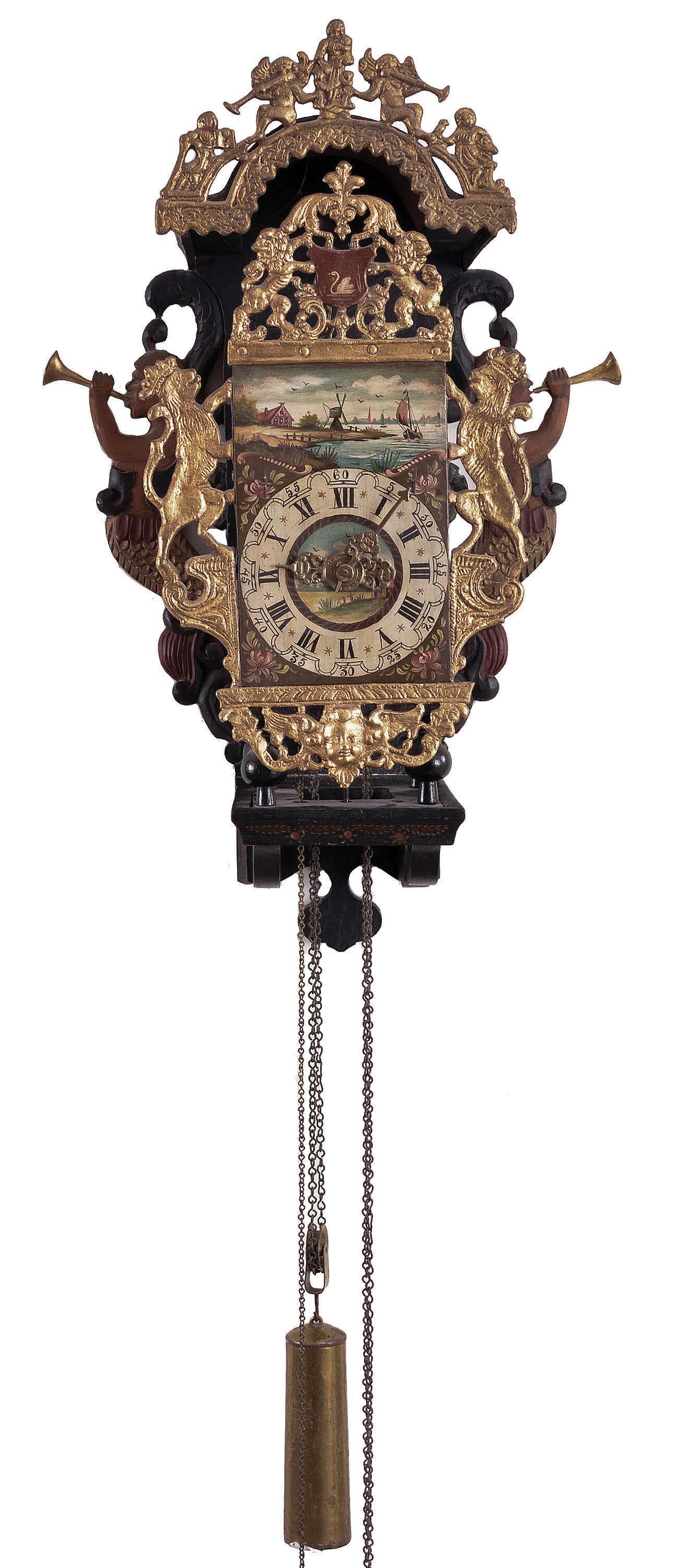 Frisian stoelklok, 30 hour, time, strike and alarm weight driven movement in a case with polychrome painted shelf with mermaids and painted floral decoration, gilded pewter ornaments including lions with crowns, roman numeral painted, arcaded dial with floral corner spandrels, central vignette with landscape, pierced brass hands, typical baluster turned brass four pillar movement, large brass pear shaped weight — Antique Clocks Price Guide