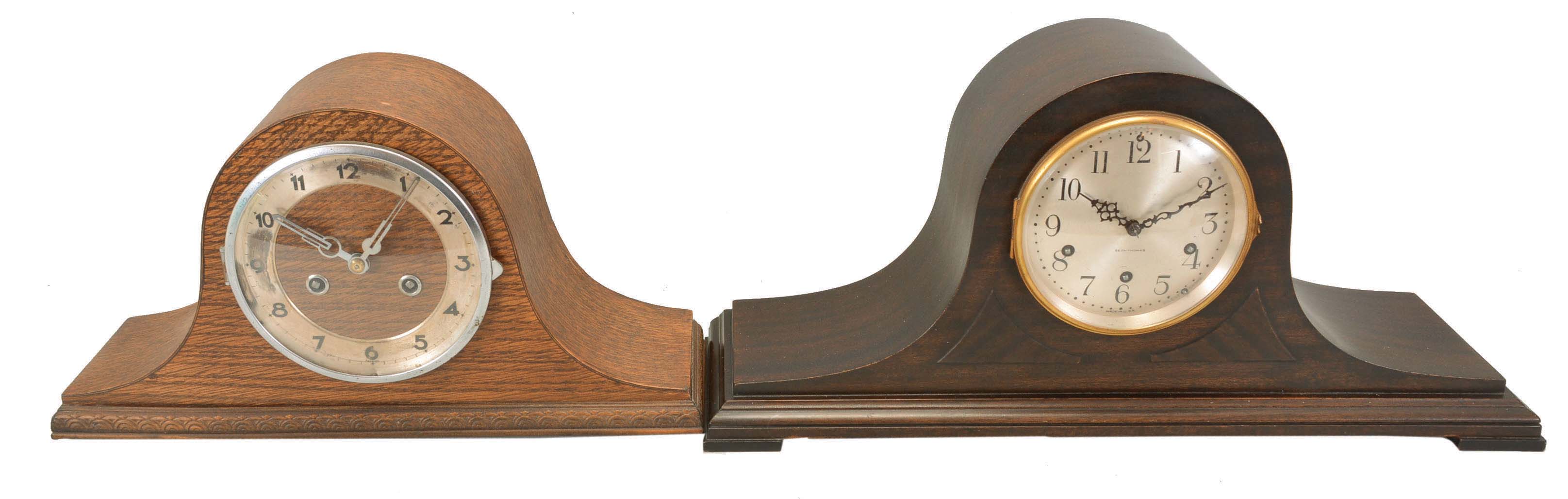 Clocks- 4 (Four) Time and Strike Mantel: (1) Seth Thomas Clock Co., tambour clock, 8 day, time and strike with Westminster chime, spring-driven No. 124 movement in a mahogaNew York case with silvered dial. (2) GermaNew York, tambour clock, 8 day, time and strike, spring-driven movement in an oak case with silvered chapter ring. (3) Ansonia Clock Co., New York, "Marbleite No. 2" mantel clock, 8 day, time and strike, spring-driven movement with visible escapement in a hard rubber case meant to simulate wood. (4) Ansonia Clock Co., New York, "La Lorne" mantel clock, 8 day, time and strike, spring-driven movement in a blue Royal Bonn porcelain case with floral motif. — Antique Clocks Price Guide
