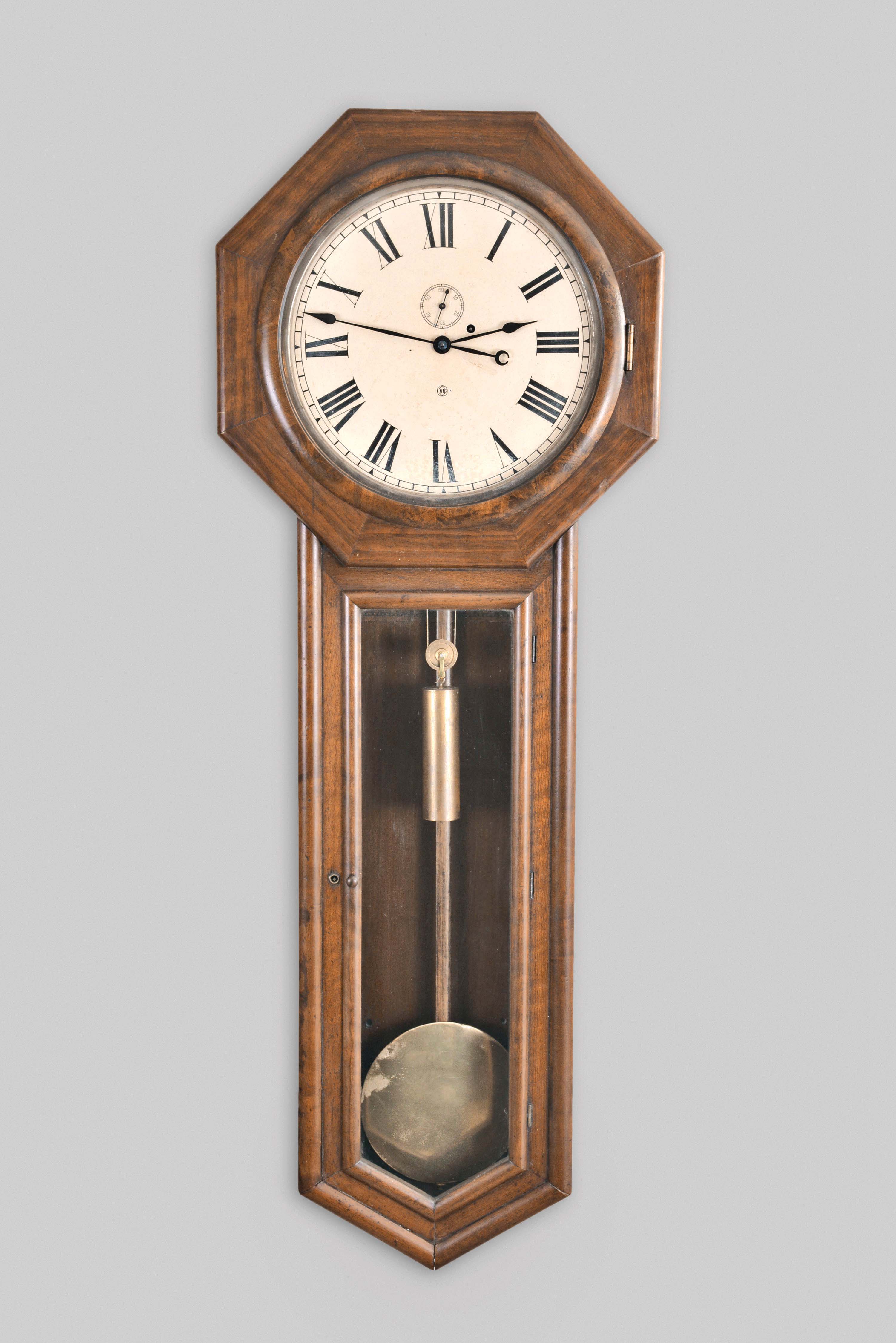 Seth Thomas Clock Co., Thomaston, Conn., "Regulator No. 18" hanging clock with a weight driven, 8 day, timepiece movement in a walnut case with burl accents. — Antique Clocks Price Guide